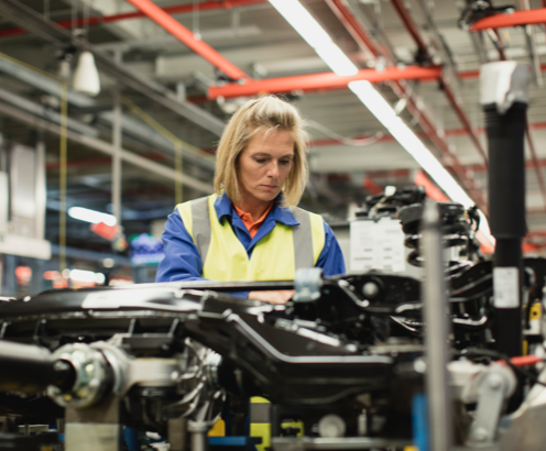 Worker performing quality inspection on an assembly line